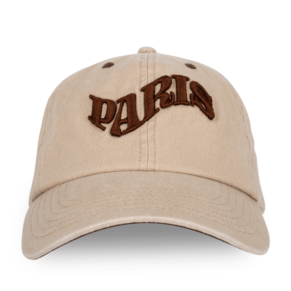 SUI AVA City Cap – beige cap med brun Paris-grafik på fronten.