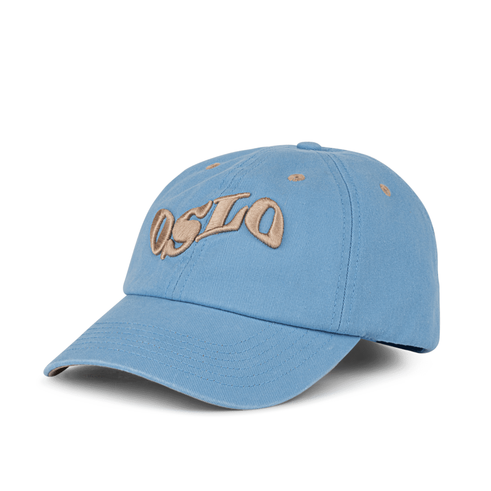 SUI AVA City Cap – blå cap med beige Oslo-grafik på fronten.