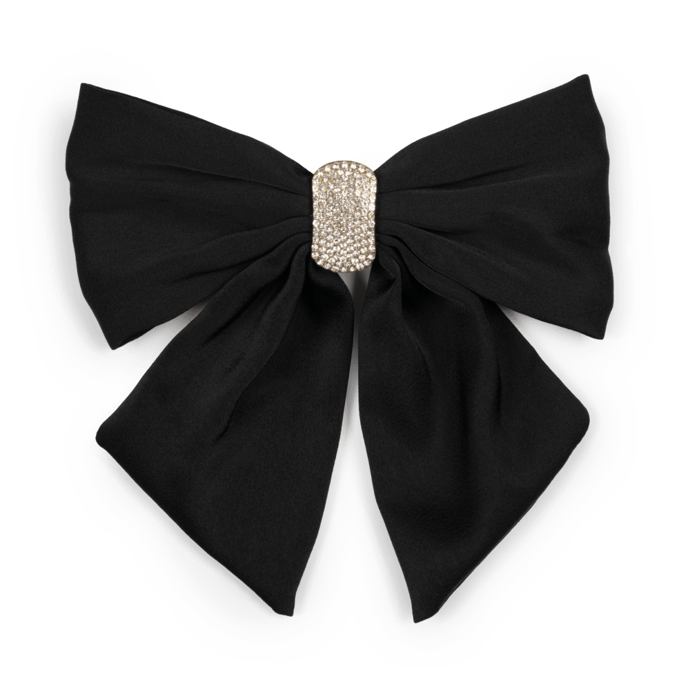 Elegant hårspænde med en stor sort sløjfe smykket med skinnende krystalsten. Moon Dust Bow tilfører et glamourøst touch til enhver frisure og lejlighed.