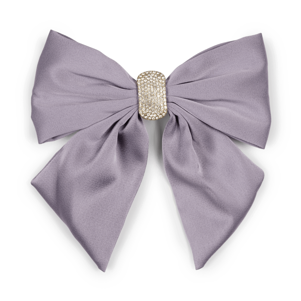 Elegant hårspænde med en stor lilla sløjfe dekoreret med funklende krystalsten. Perfekt til at tilføje et glamourøst touch til enhver frisure.
