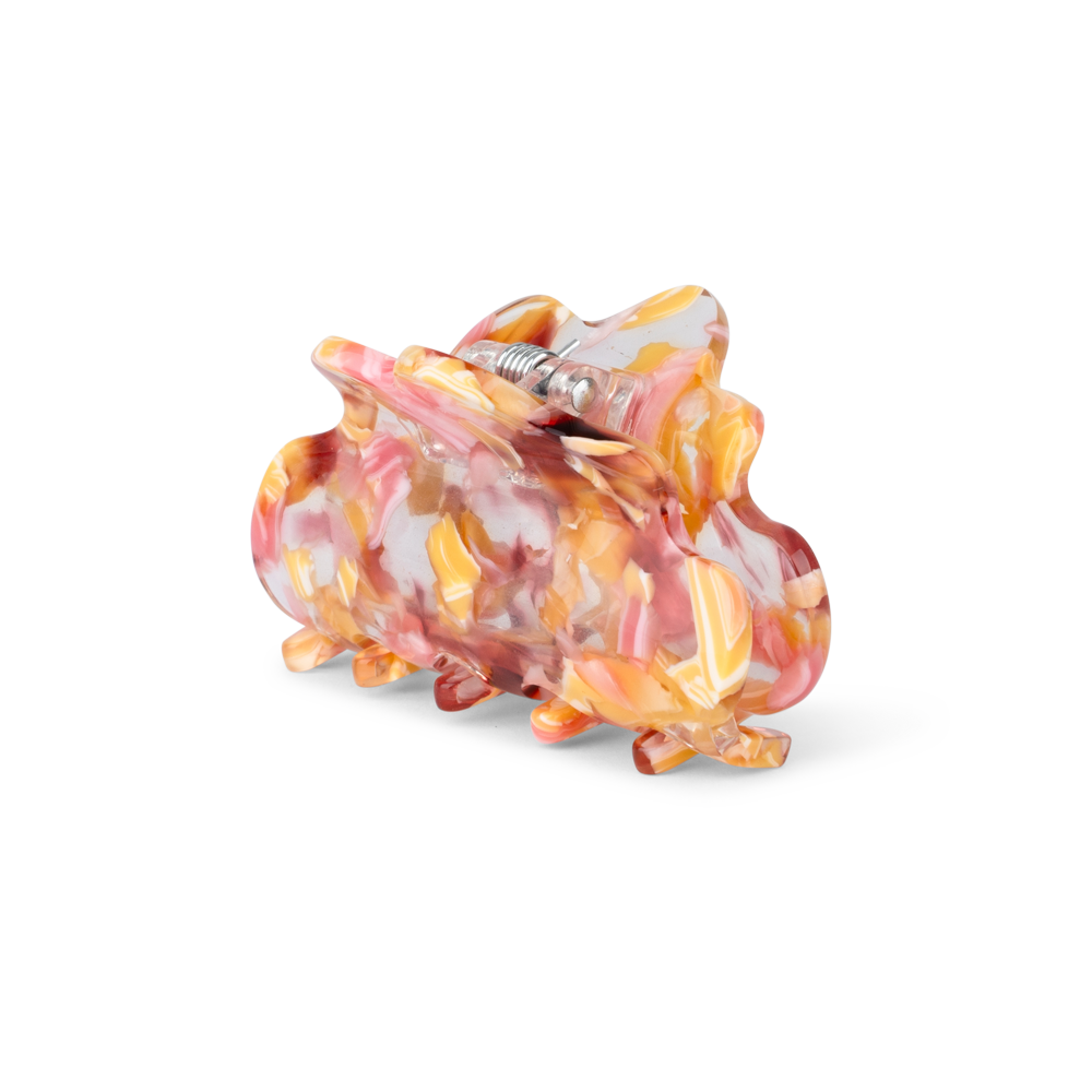 Pernille Wavy Mini hårklemme med flydende mønster i rosa, orange og gyldne nuancer – lille størrelse.