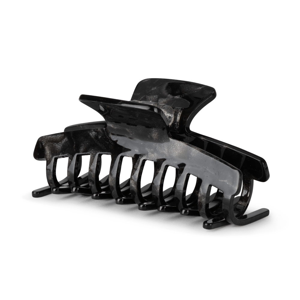 Lea Stardust Big fra SUI AVA – stor hårklemme med glitrende stjernedetaljer, ideel til at skabe elegante og iøjnefaldende frisurer med et festligt touch.