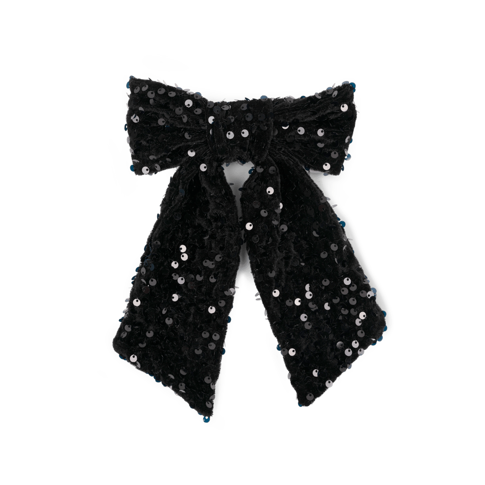 Anne Sequins Bow fra SUI AVA – smuk hårsløjfe med glitrende pailletter i en klassisk stil, ideel til at skabe et elegant og iøjnefaldende look.