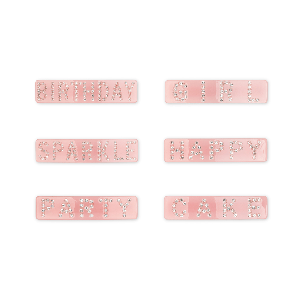 Rosa hårspænde med teksten HAPPY i rhinsten fra SUI AVA