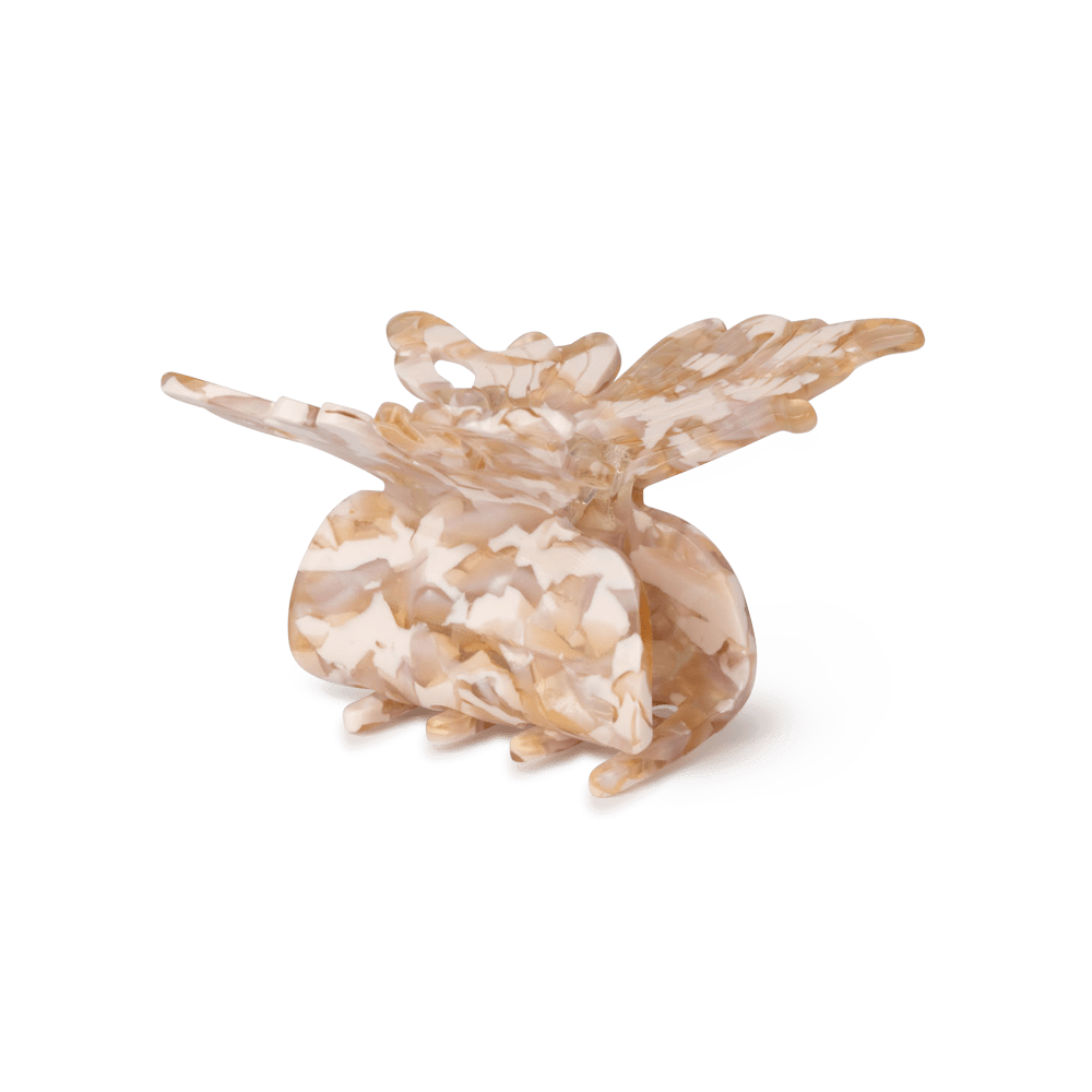 Lysbrun hårklemme fra SUI AVA formet som en sommerfugl med marmoreret mønster og bløde nuancer.