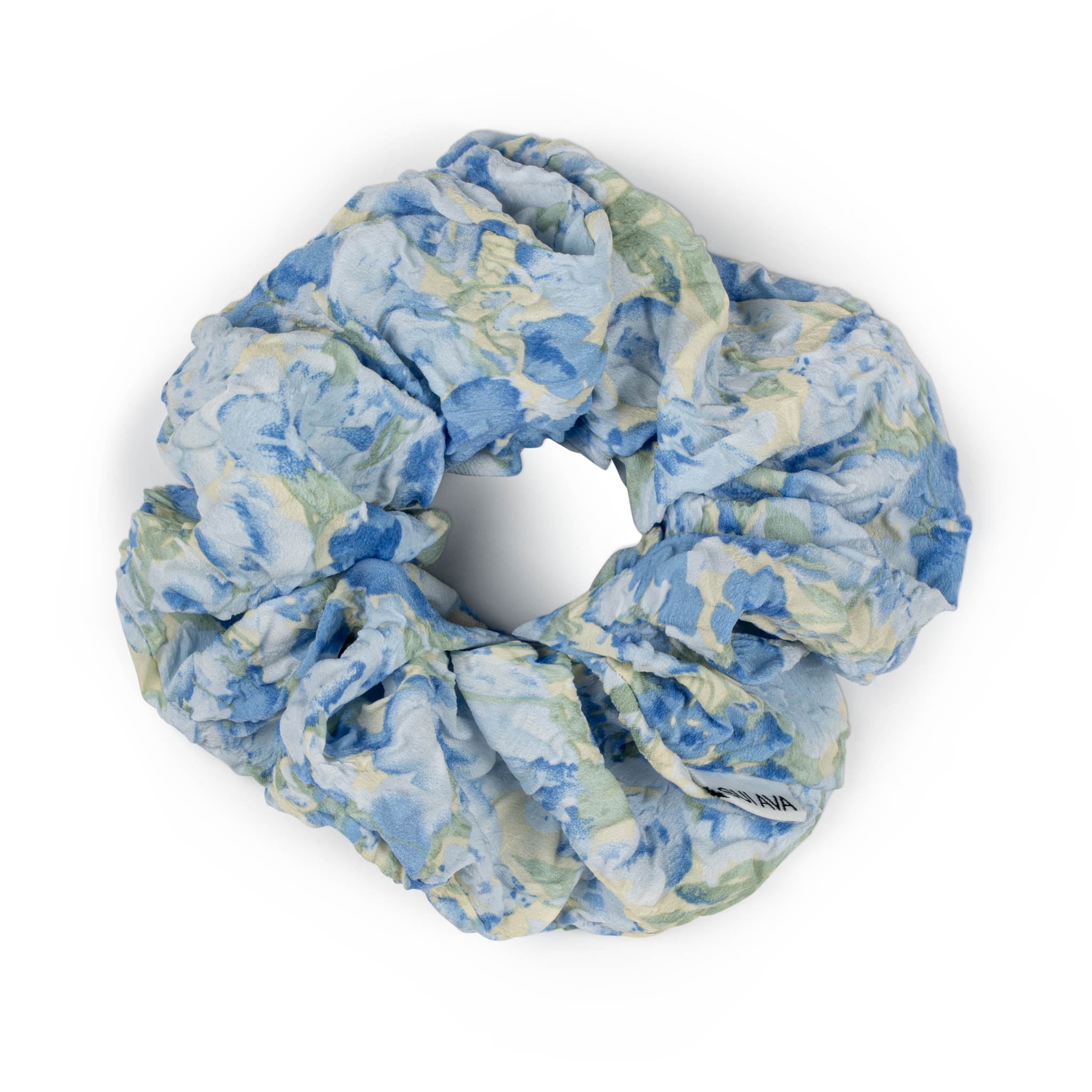 Julie Wildflower Scrunchie i blå – Blød scrunchie med blomsterprint i blå og grønne nuancer.